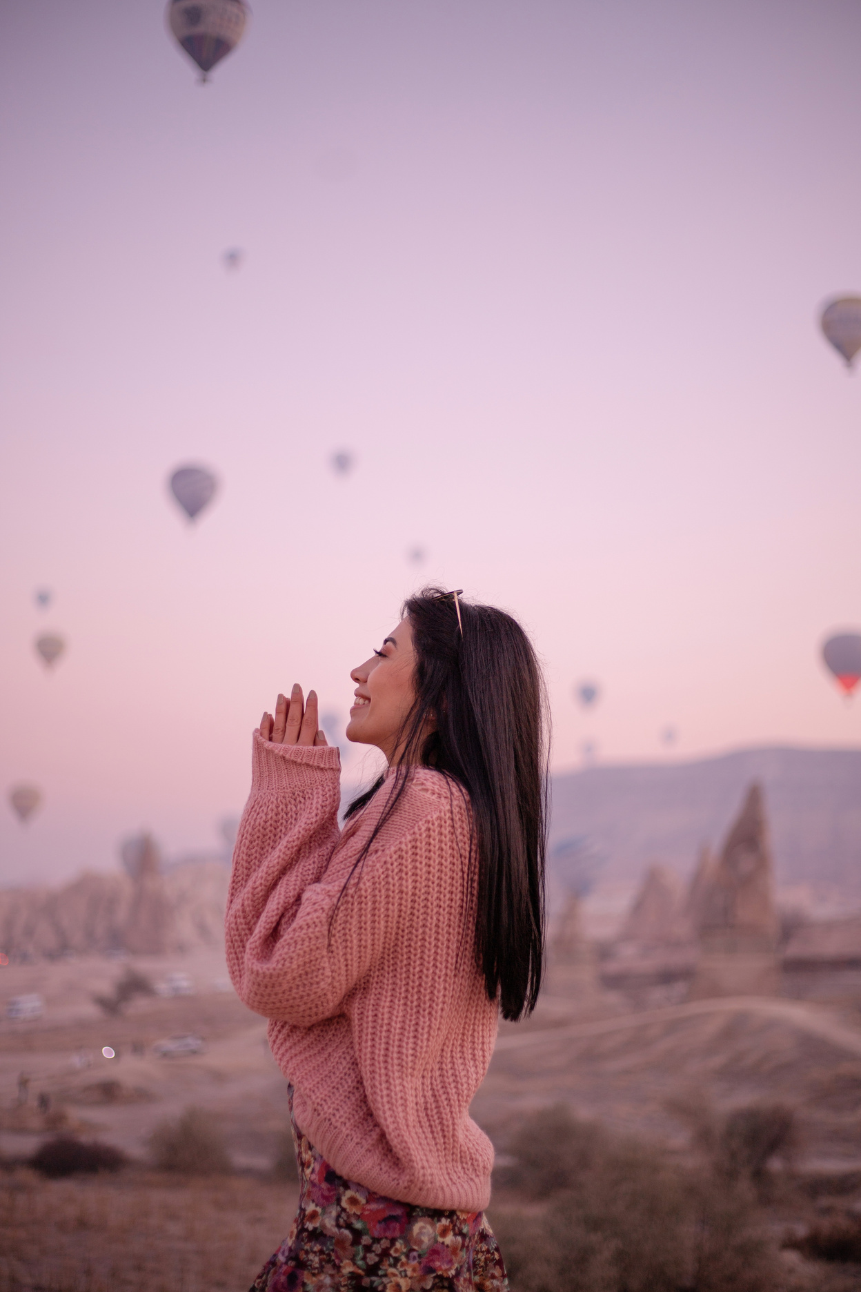 Happy Woman Standing Outdoors against the Hot Air Balloons