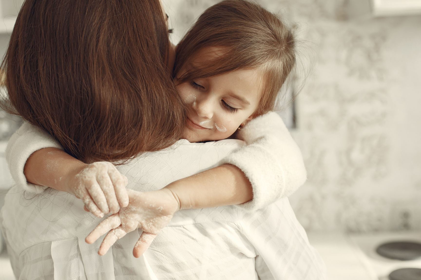 Mother and Daughter Hugging with Flour on their Hands