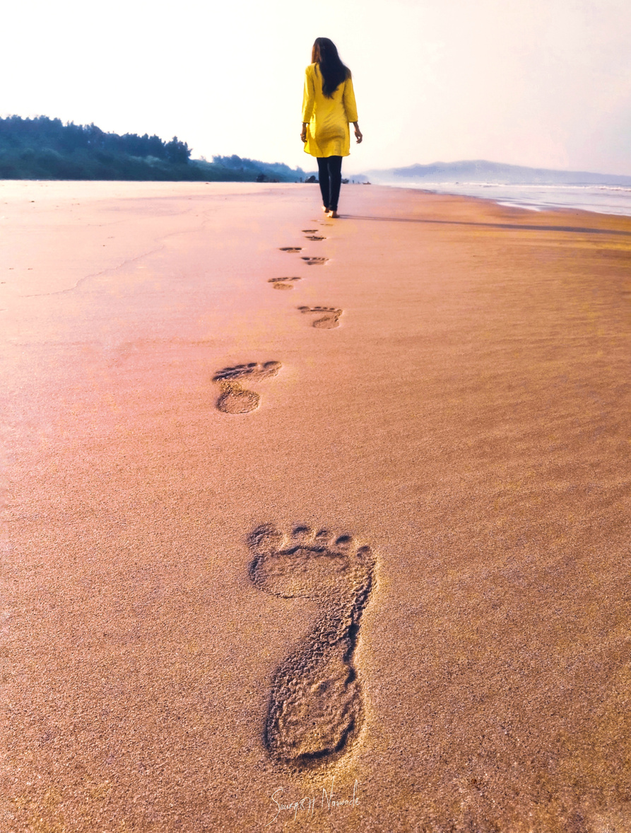Photo of Woman Walking On Seashore